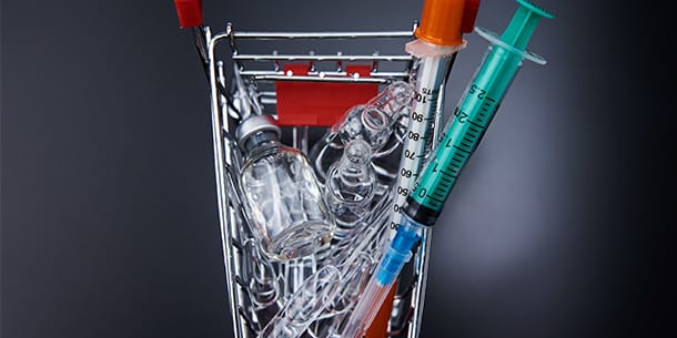 Shopping cart filled with used syringes and medical vials
