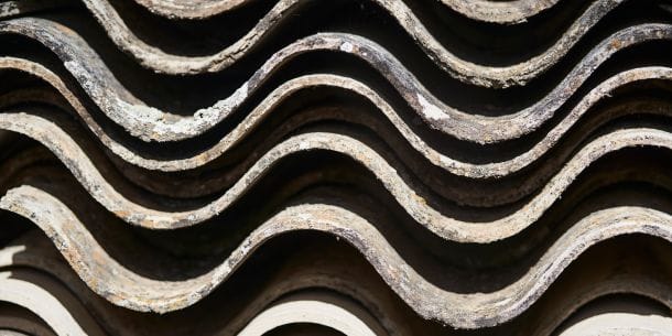 Close-up of stacked corrugated asbestos cement sheets