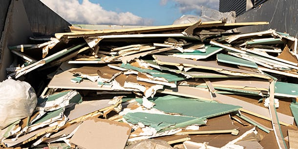 Broken plasterboard sheets in a skip